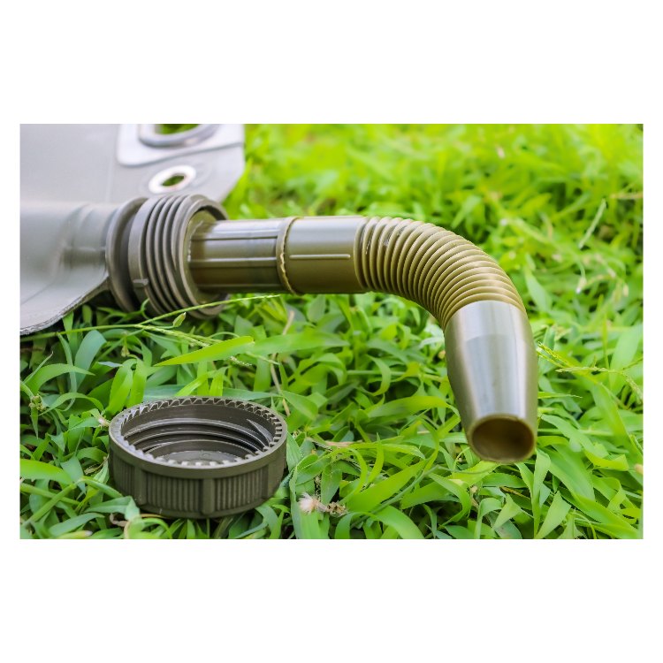 A close-up of a gray fuel tank, corrugated hose attached to a black cap with a threaded fitting, placed on a grassy surface. The hose has a ribbed texture, and the cap features a secure, screw-on design.