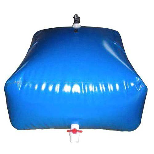A blue, square inflatable water bladder with a black cap on top and a white valve with a red cap on the side rests on a surface, filled with water.