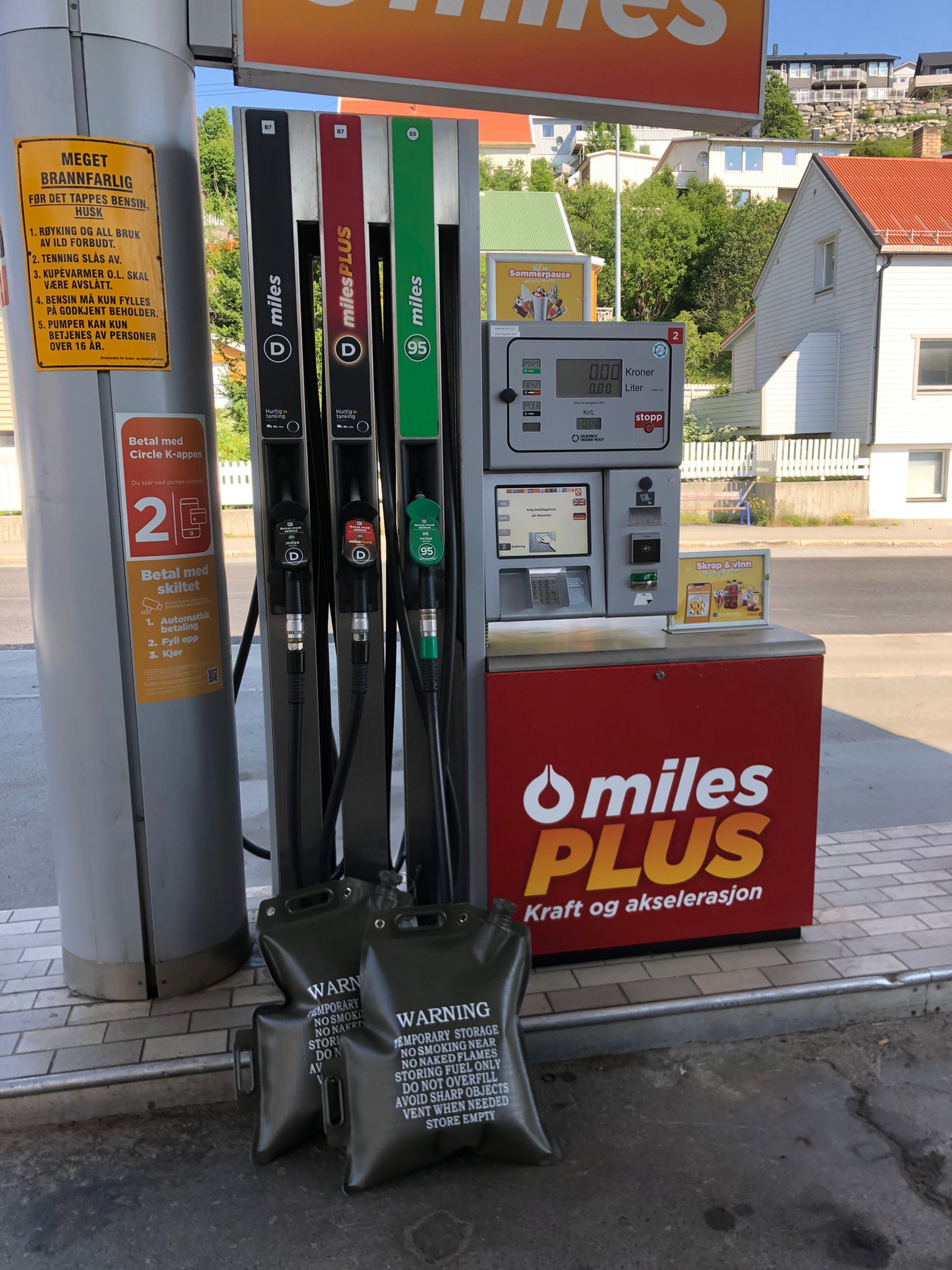 A gas pump with multiple fuel nozzles and 'miles PLUS' branding,