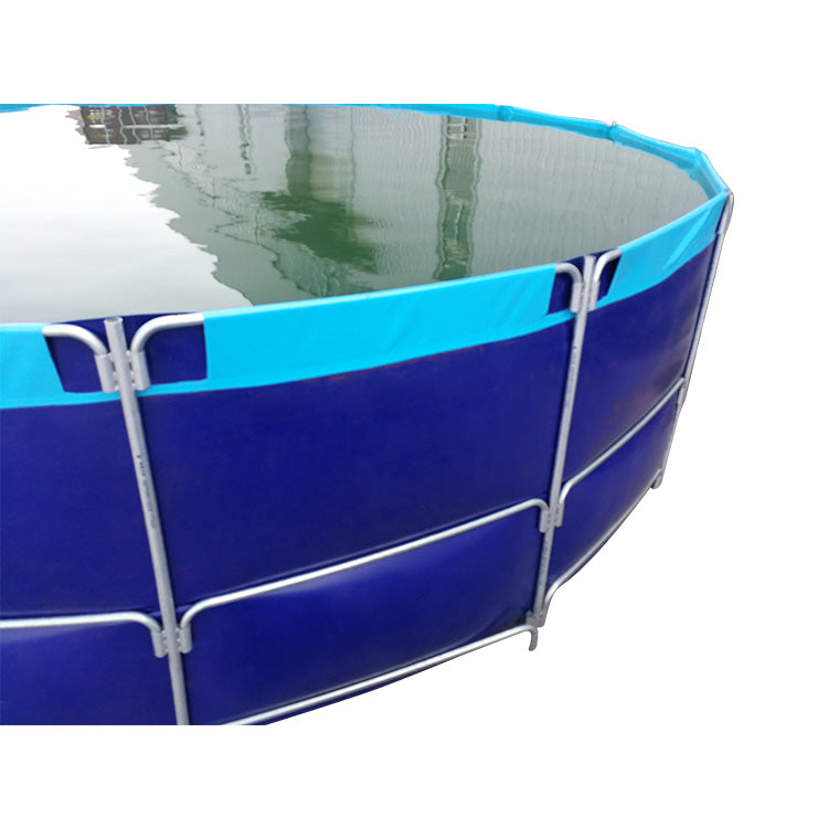 A round blue above-ground fish farming tank filled with water, supported by a sturdy metal frame.